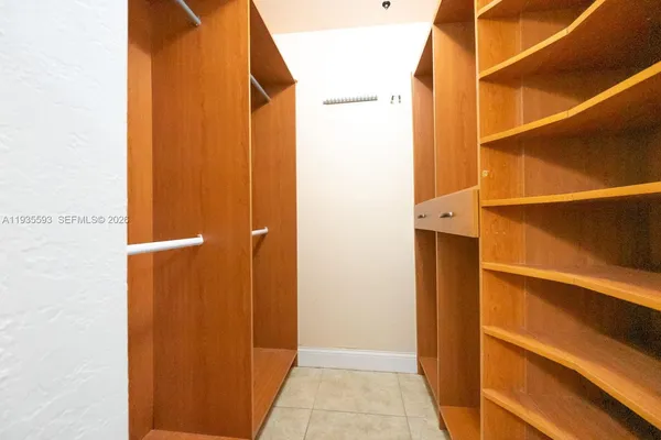 a kitchen with granite countertop kitchen island a sink stainless steel appliances and cabinets
