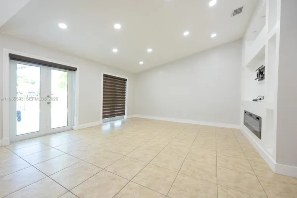 a kitchen with stainless steel appliances granite countertop a refrigerator and a stove