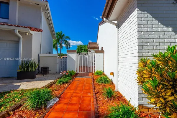 a backyard of a house with flower plants