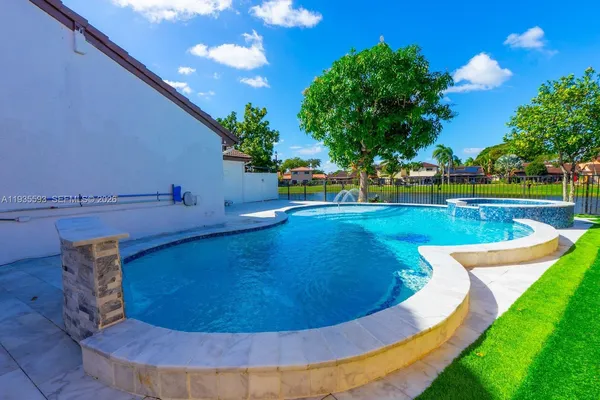 a view of a swimming pool with an outdoor space and seating area