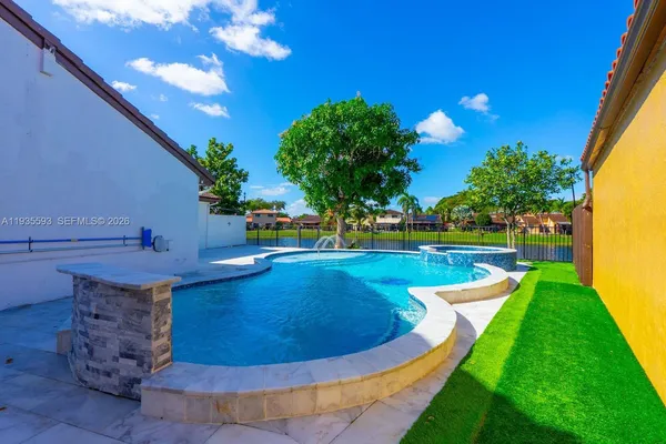 a view of a swimming pool with a yard