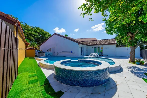 a view of a backyard with plants and patio