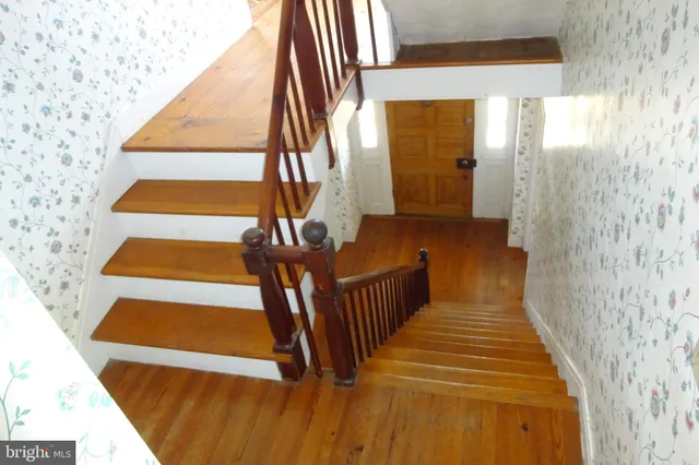 an empty room with a fireplace and window