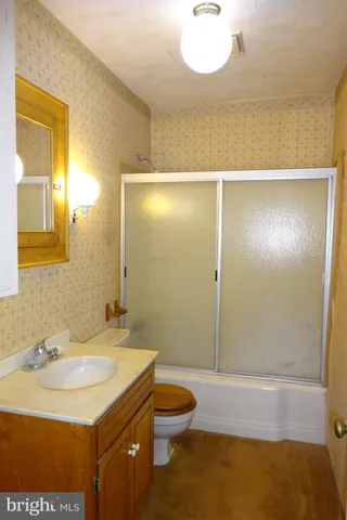 a view of a yard with plants and trees