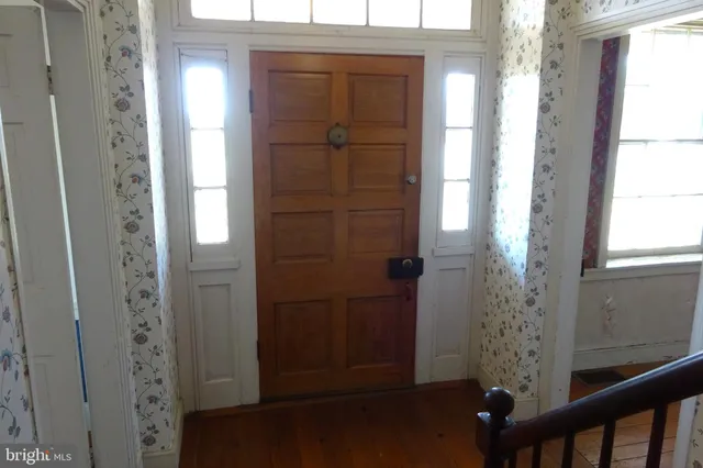 a room with wooden floor and a fireplace
