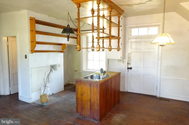 a bathroom with a granite countertop sink a mirror and a shower