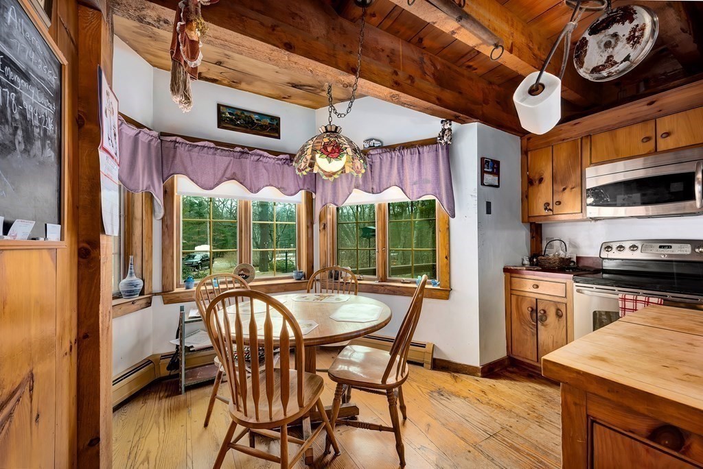357 Ipswich Road Boxford, MA 01921 - Photo 8 of 28 a view of a dining room with furniture large wooden floor and a chandelier