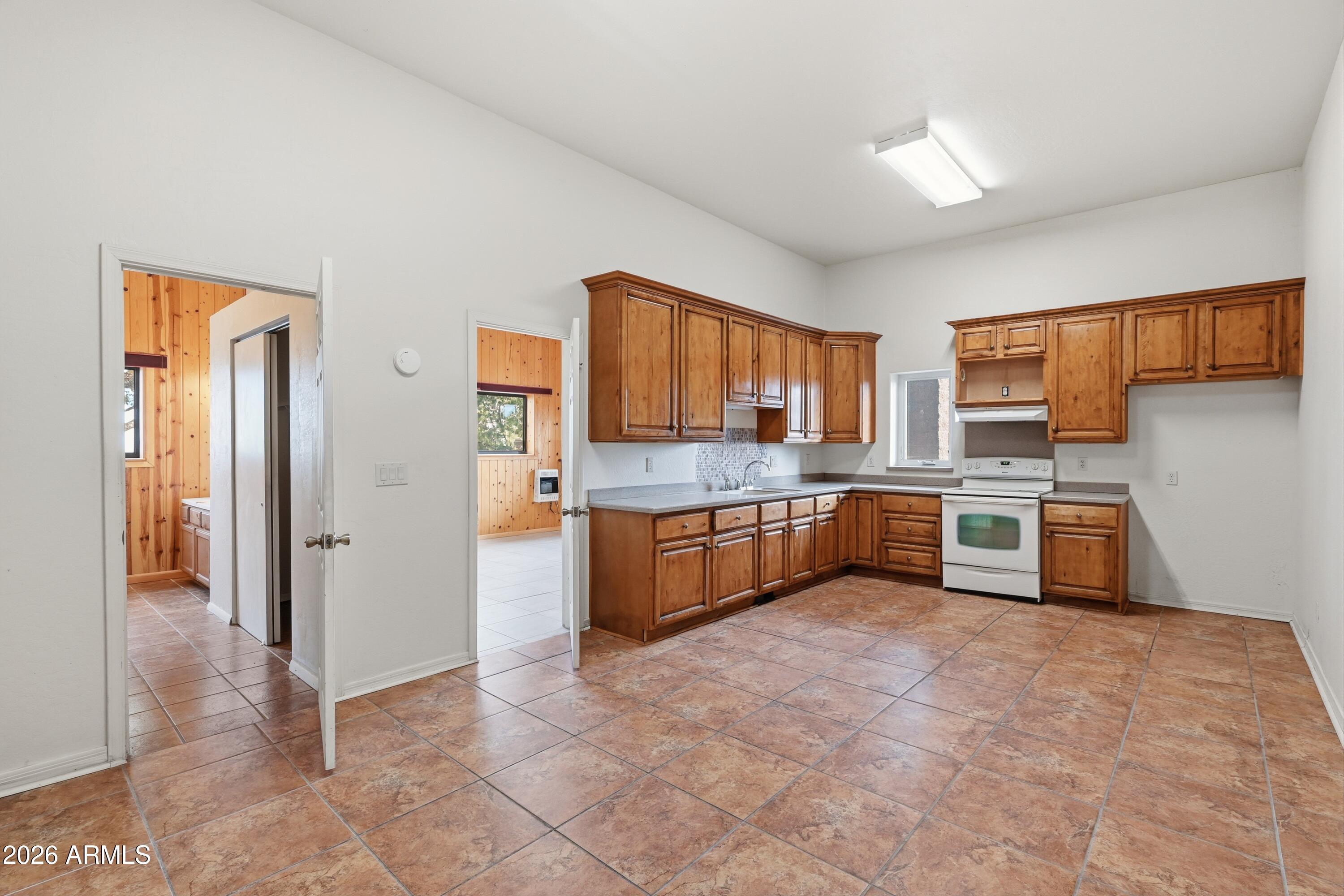 1561 South Canyon Ridge Trail Show Low, AZ 85901 - Photo 44 of 61 a large kitchen with stainless steel appliances cabinets a sink and a counter top space