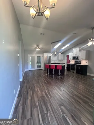 a room with wooden floor and pool table