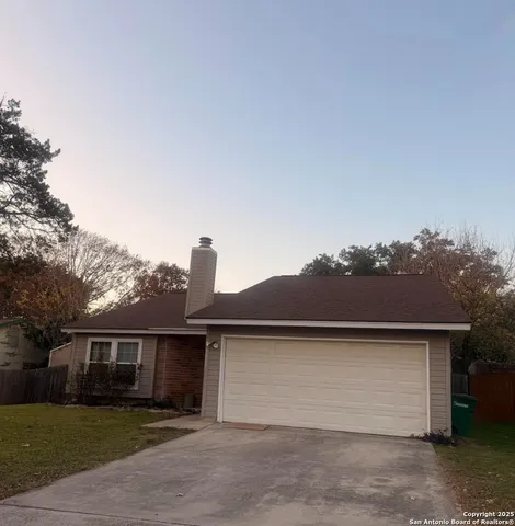 a front view of house with yard and trees