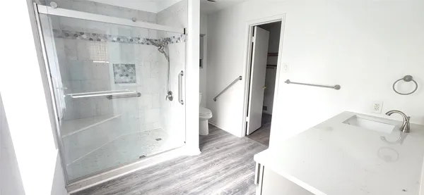 a bathroom with a shower and a sink