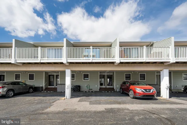 a front view of a building with parking space