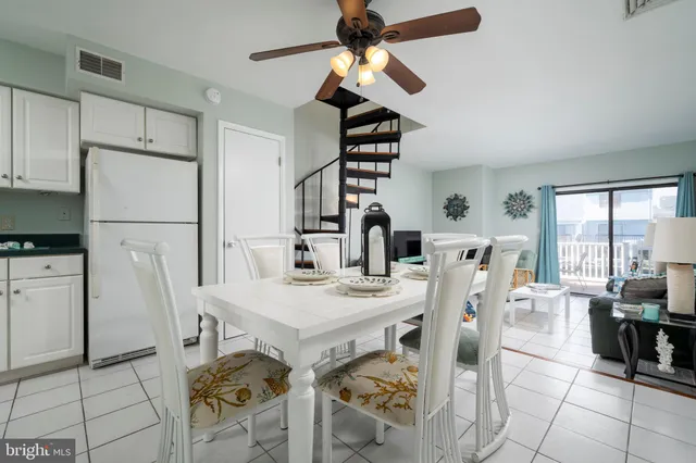 a view of a dining room with furniture and a chandelier