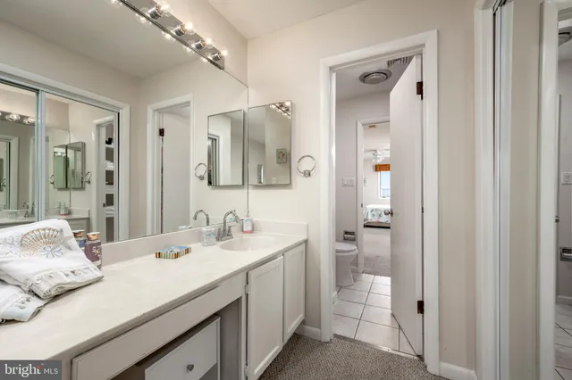 a bathroom with double vanity sinks and a mirror