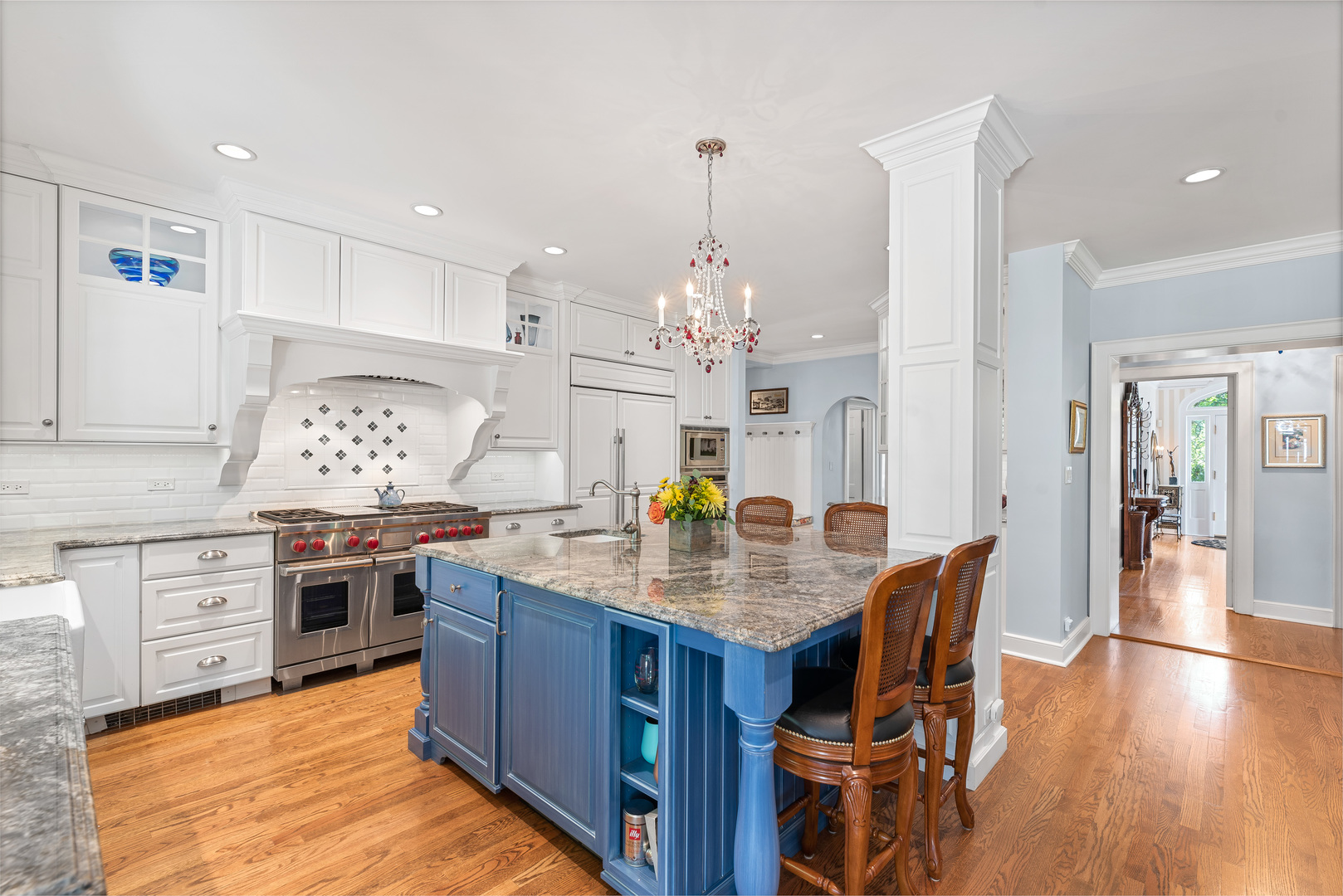 611 County Line Road Highland Park, IL 60035 - Photo 16 of 49 a kitchen with granite countertop center island wooden floor stainless steel appliances and cabinets