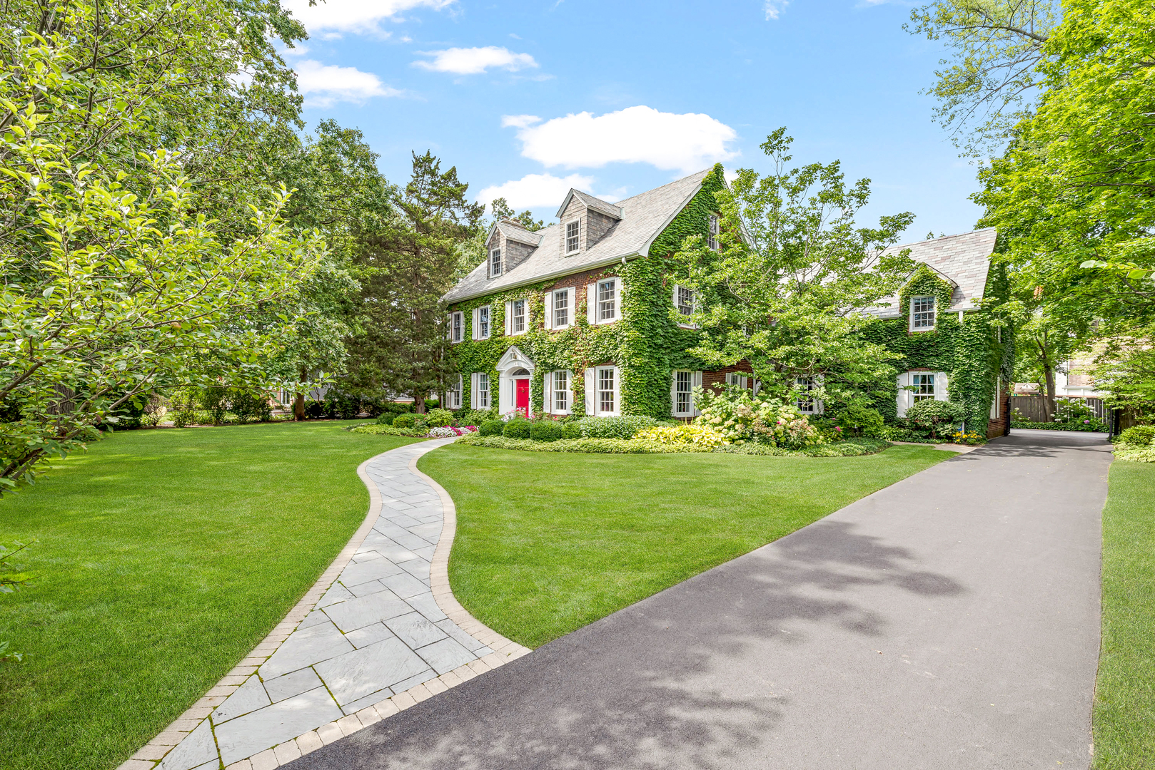 611 County Line Road Highland Park, IL 60035 - Photo 2 of 49 a view of a white house with a big yard and potted plants and large trees