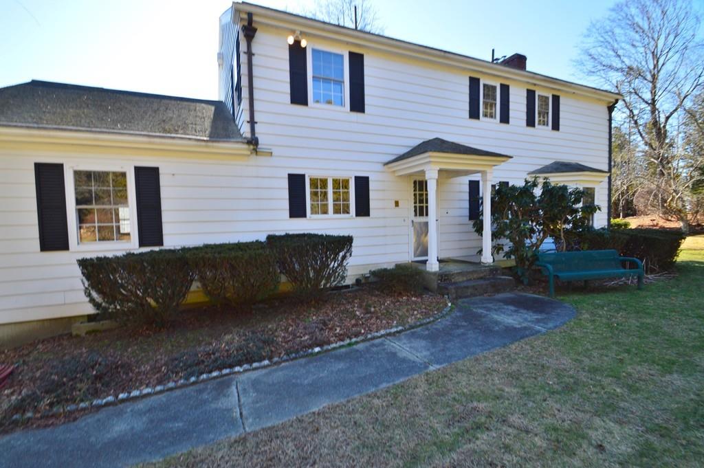 a view of a house with backyard and sitting area