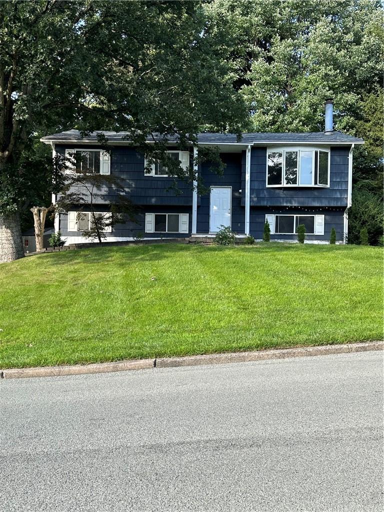 a front view of house with yard and green space