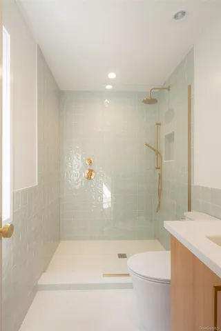 a bathroom with a shower a toilet and bathtub