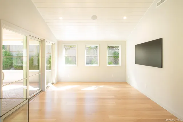 a view of an empty room with glass door