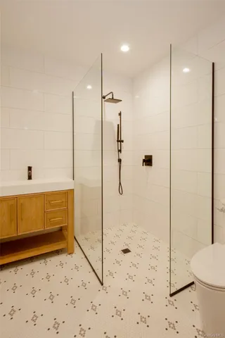 a bathroom with a shower a toilet and sink