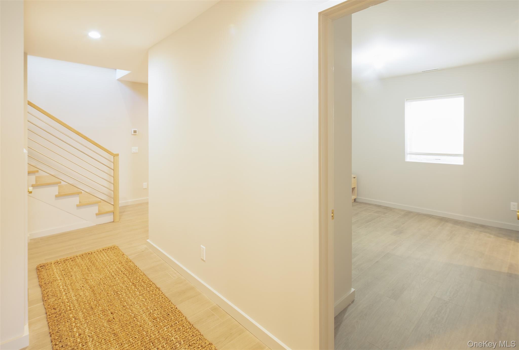 195 Little Fresh Pond Road Southampton, NY 11968 - Photo 30 of 40 Corridor featuring light wood-style floors, stairs, and recessed lighting