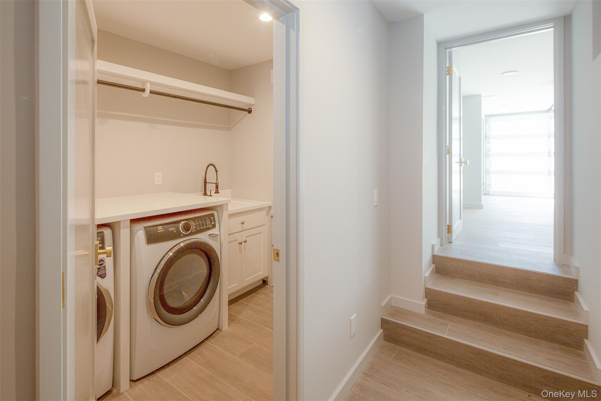 195 Little Fresh Pond Road Southampton, NY 11968 - Photo 31 of 40 Laundry room featuring washer / clothes dryer and light wood-style floors