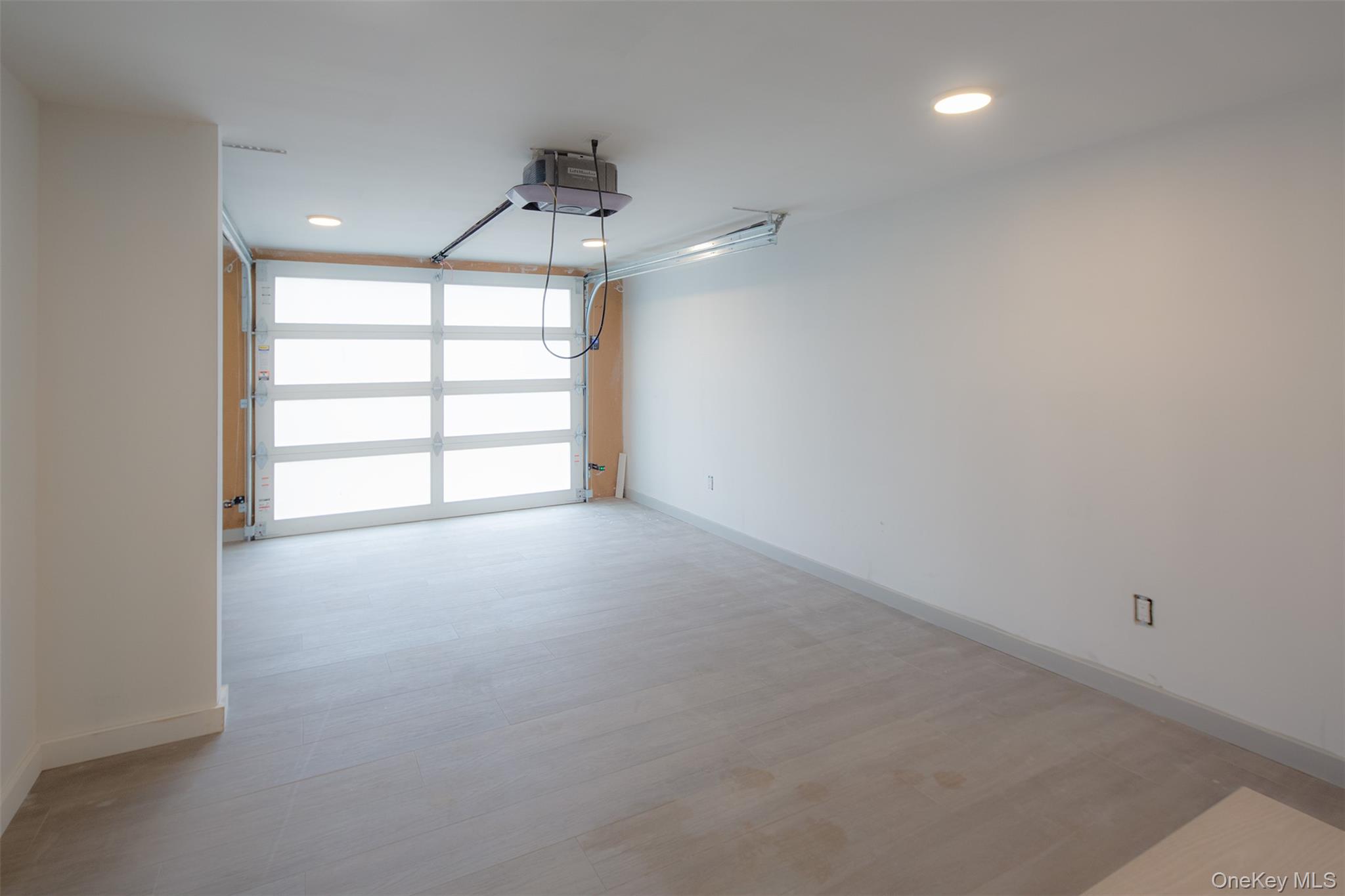 195 Little Fresh Pond Road Southampton, NY 11968 - Photo 34 of 40 Garage with recessed lighting and a garage door opener