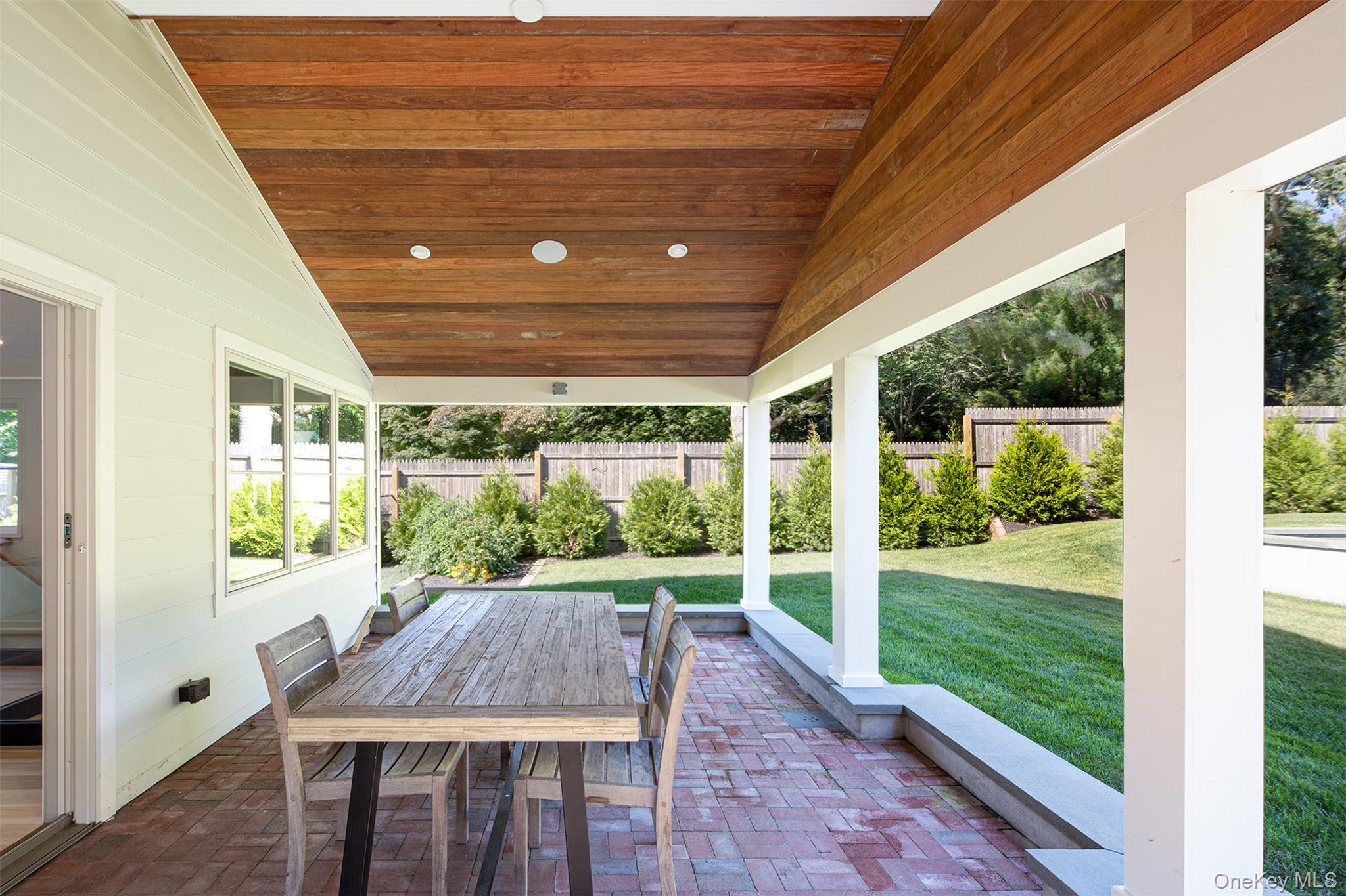 195 Little Fresh Pond Road Southampton, NY 11968 - Photo 36 of 40 Fenced backyard featuring a patio and outdoor dining area