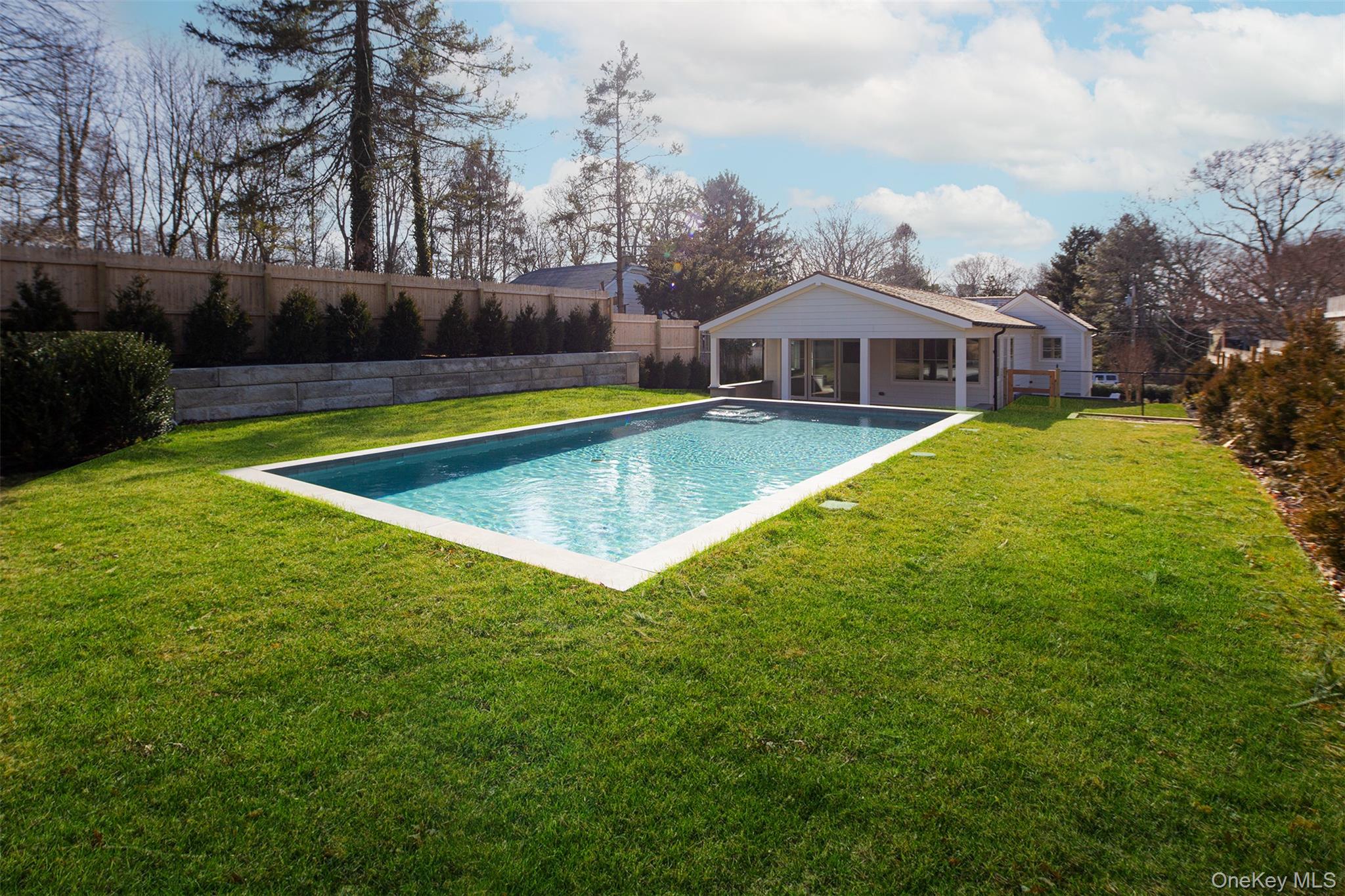 195 Little Fresh Pond Road Southampton, NY 11968 - Photo 39 of 40 View of pool featuring a fenced backyard, a patio area, and a sunroom