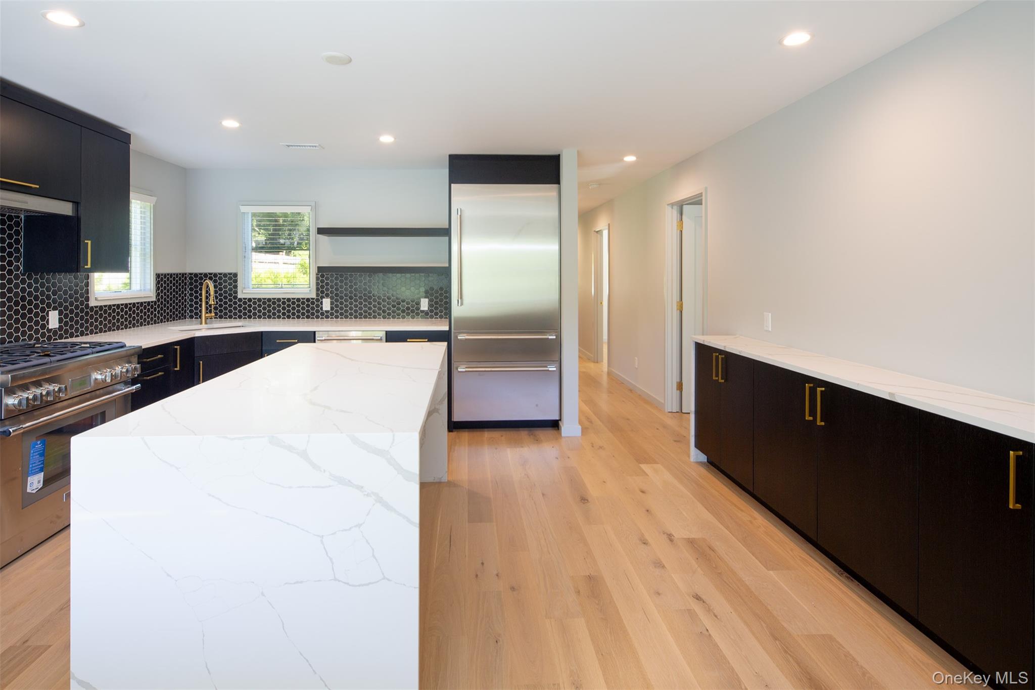 195 Little Fresh Pond Road Southampton, NY 11968 - Photo 7 of 40 Kitchen with light stone counters, recessed lighting, dark cabinets, high end appliances, and open shelves