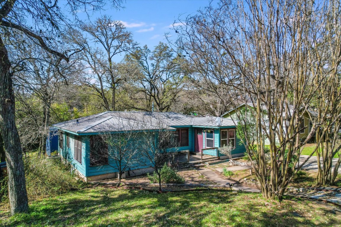 a backyard of a house with yard barbeque oven and outdoor seating