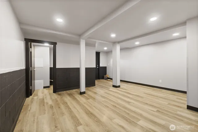 a view of an empty room with wooden floor