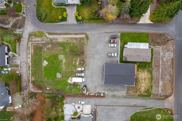 an aerial view of a residential houses with yard