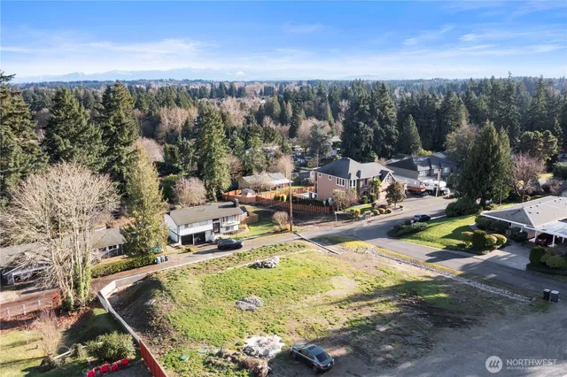 a view of a swimming pool with a patio and a yard