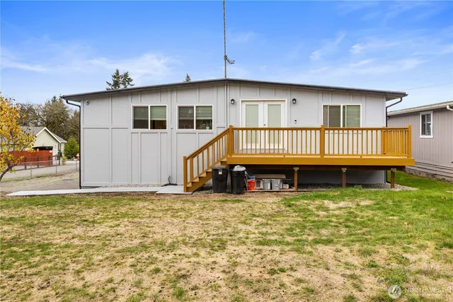 a view of a house with pool and chairs
