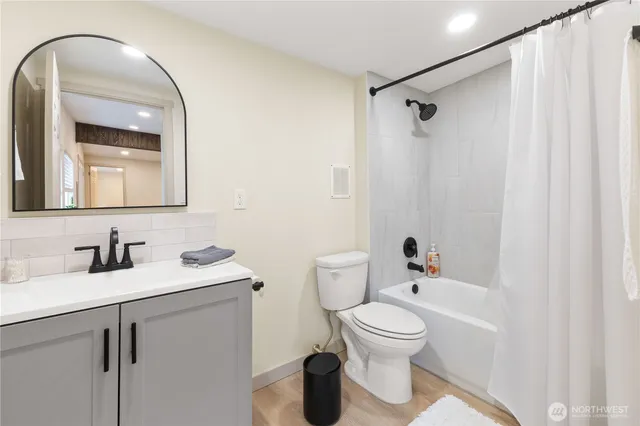 a bathroom with a toilet sink and mirror