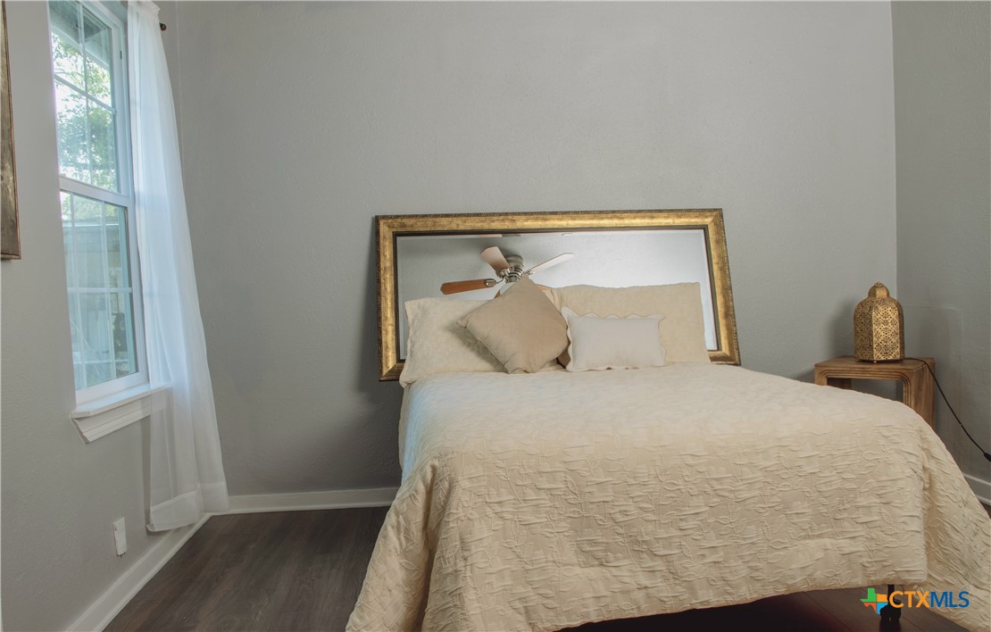 1407 South 7th Street Temple, TX 76504 - Photo 16 of 36 a large bed sitting in a bedroom next to a window