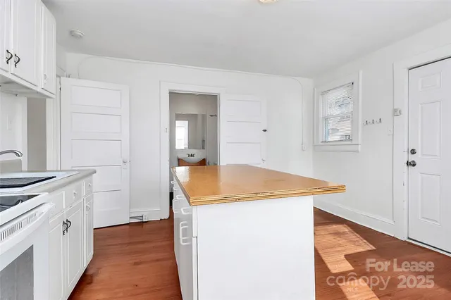a kitchen with stainless steel appliances granite countertop a sink and a refrigerator