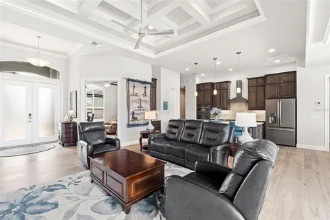 a living room with furniture or kitchen view and a wooden floor