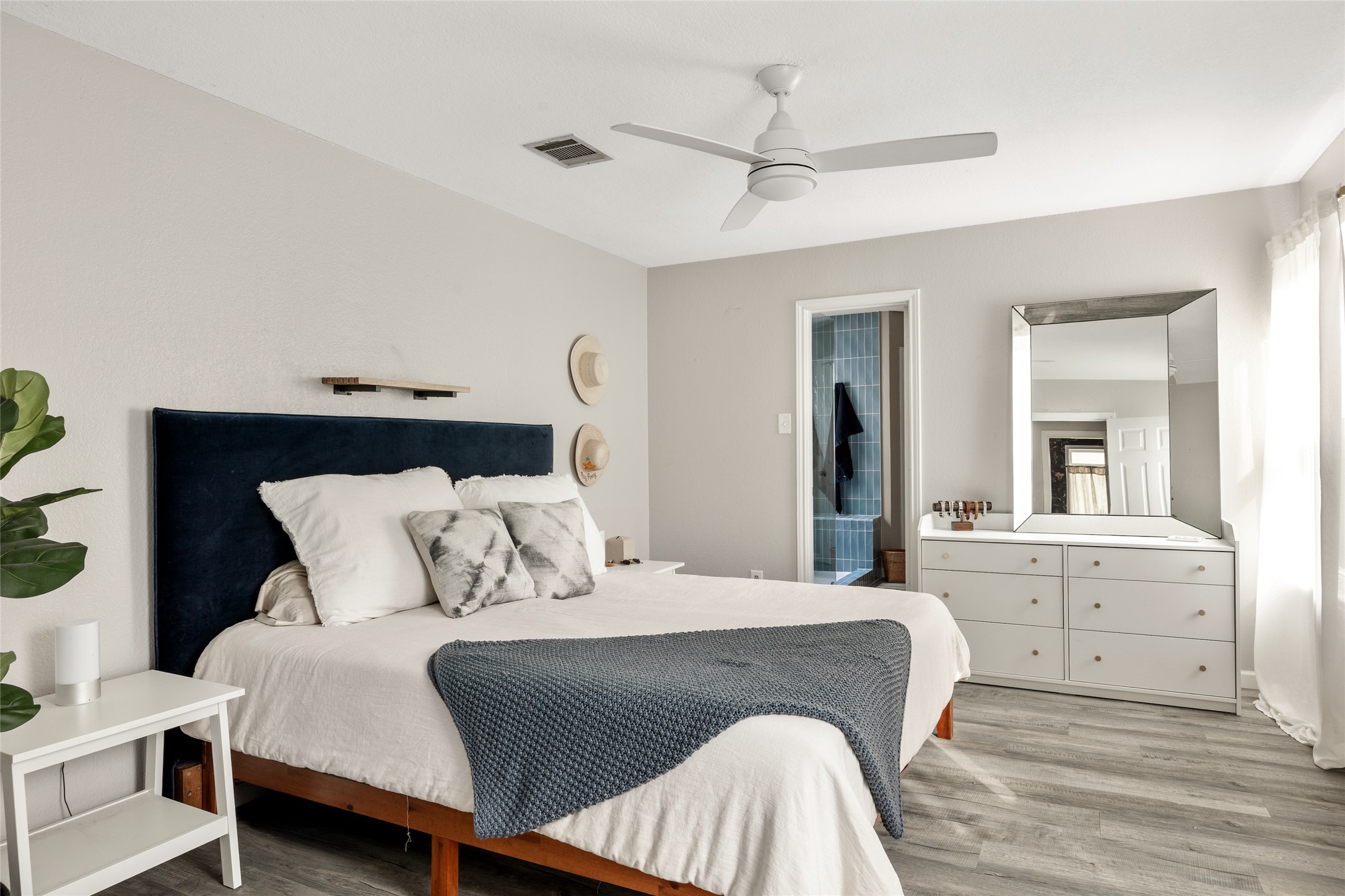 8504 Verona Trail Austin, TX 78749 - Photo 17 of 32 a bedroom with a large bed and a chandelier