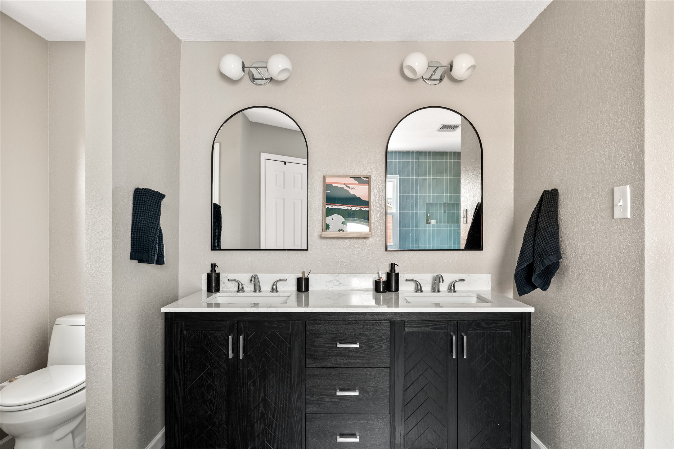 8504 Verona Trail Austin, TX 78749 - Photo 21 of 32 a bathroom with a double vanity sink and a mirror