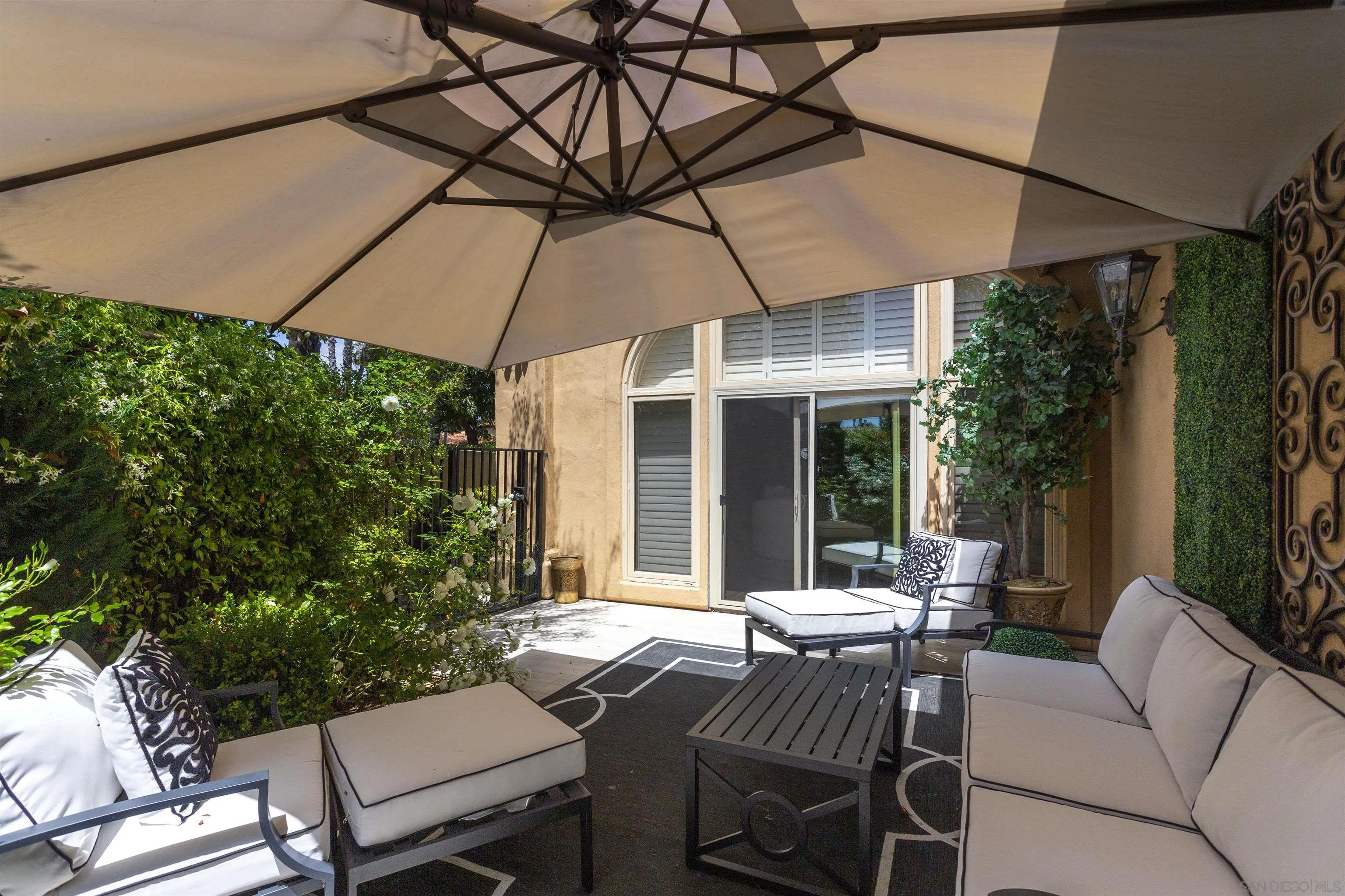 15448 Pimlico Corte Rancho Santa Fe, CA 92067 - Photo 8 of 31 a view of a patio with a table and chairs under an umbrella