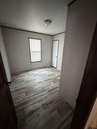 a view of room with window and hardwood floor