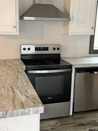a stove top oven sitting inside of a kitchen