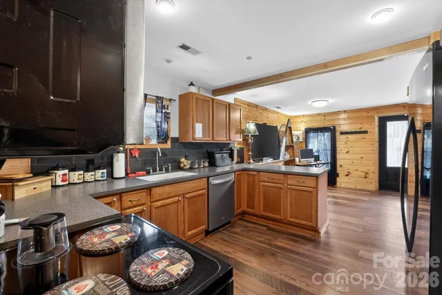 a kitchen with stainless steel appliances granite countertop a sink and cabinets