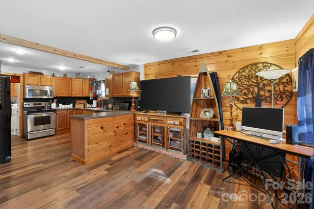a kitchen with stainless steel appliances a stove top oven and a refrigerator