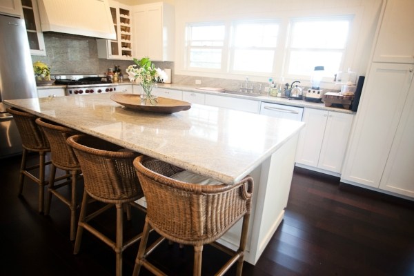 3765 Omao Road, Unit B Koloa, HI 96756 - Photo 6 of 16 a kitchen with kitchen island granite countertop a sink a stove and a wooden floor
