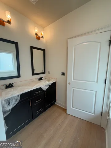 a bathroom with a double vanity sink and mirror