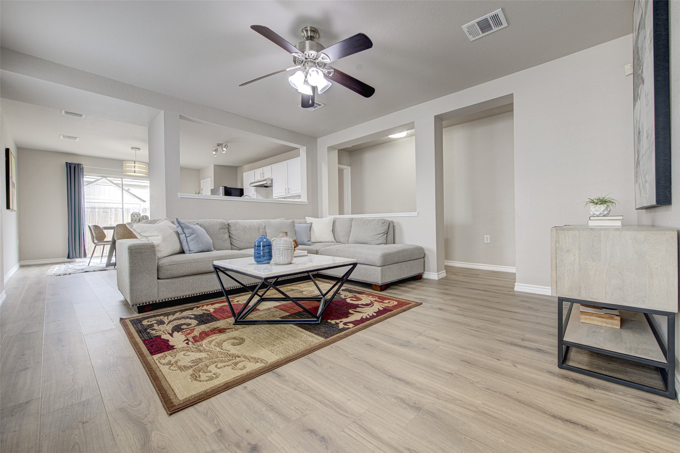 6709 Doyal Drive Austin, TX 78747 - Photo 4 of 22 Living area with ceiling fan and light wood-style flooring